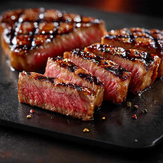 Sliced steak on a dark surface with a close-up view