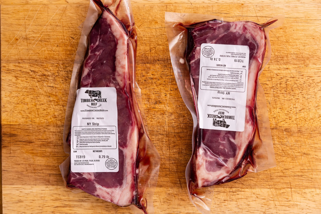 Two packages of raw meat with labels on a wooden surface
