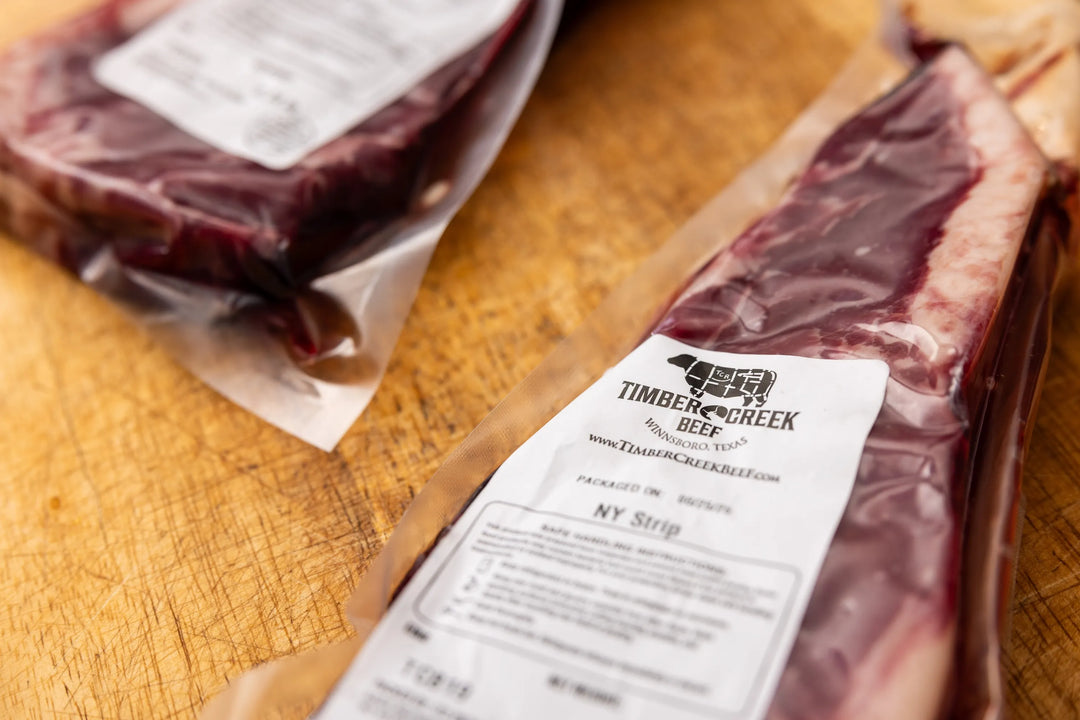 Packaged beef with Timber Creek Beef label on a wooden surface